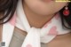 A close up of a doll wearing a scarf with hearts on it.