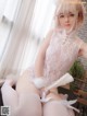 a woman in a white lingerie sitting on a chair